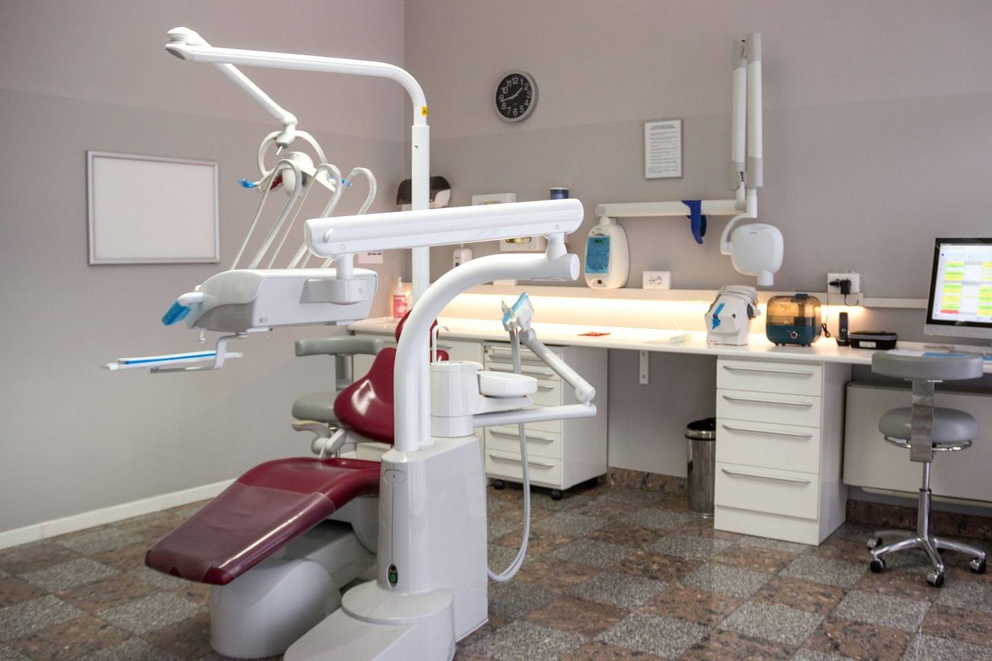 Empty dental chair with tools in a clean office.
